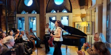 Ezo Sarıcı and Deniz Cengiz of Duo Ekeš receiving applause at St Pancras Clock Tower